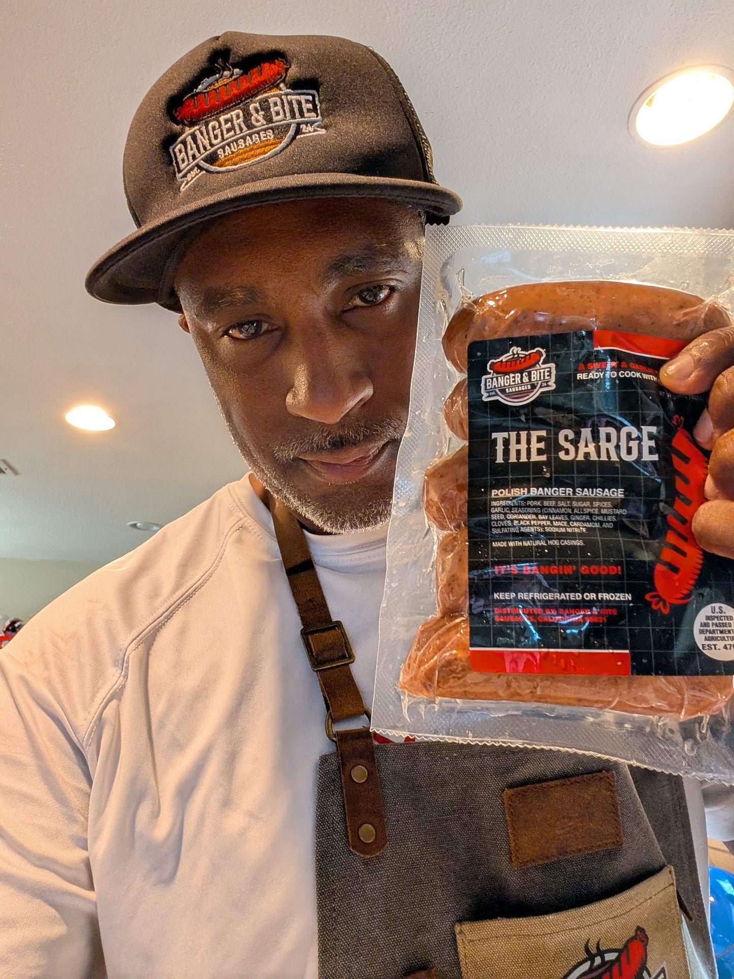 Our founder, Malcolm, holding up the sausage pack, "The Sarge"