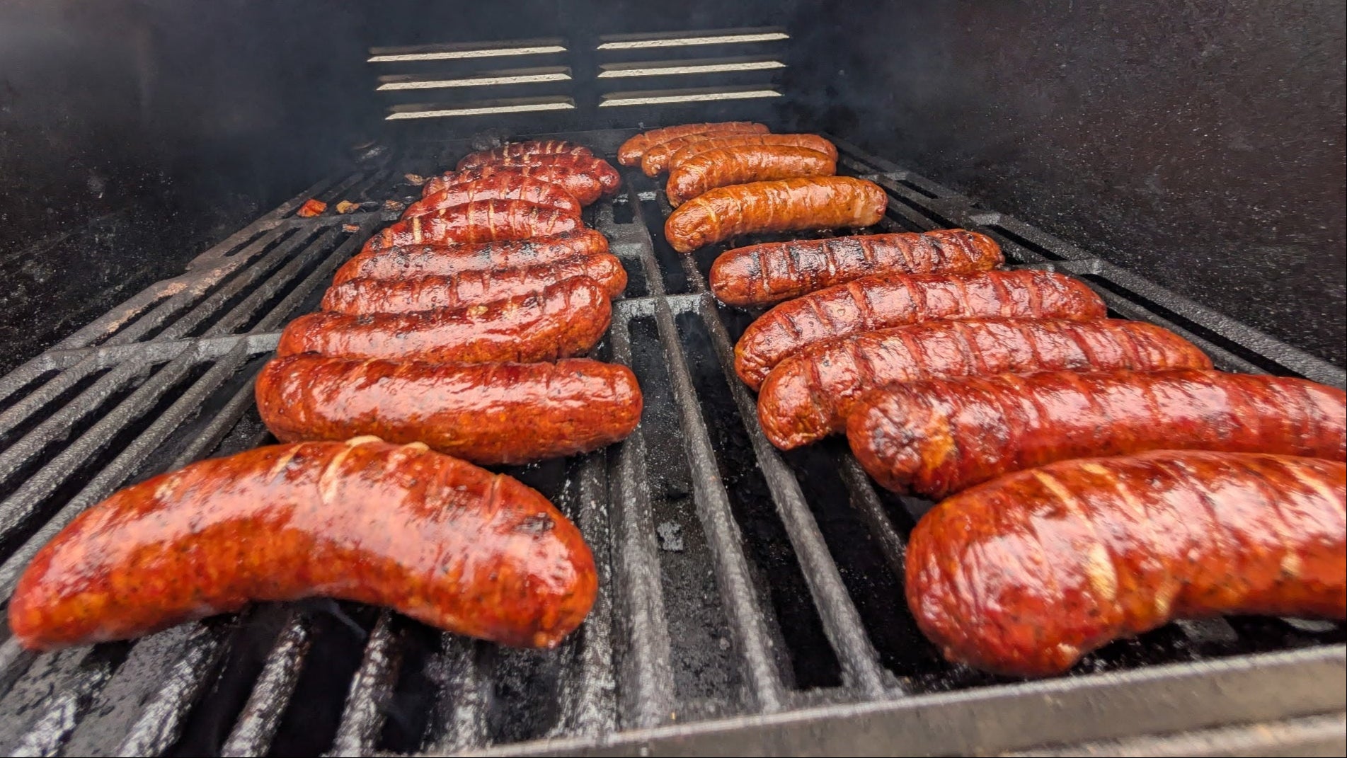 Cooking sausages at the grill