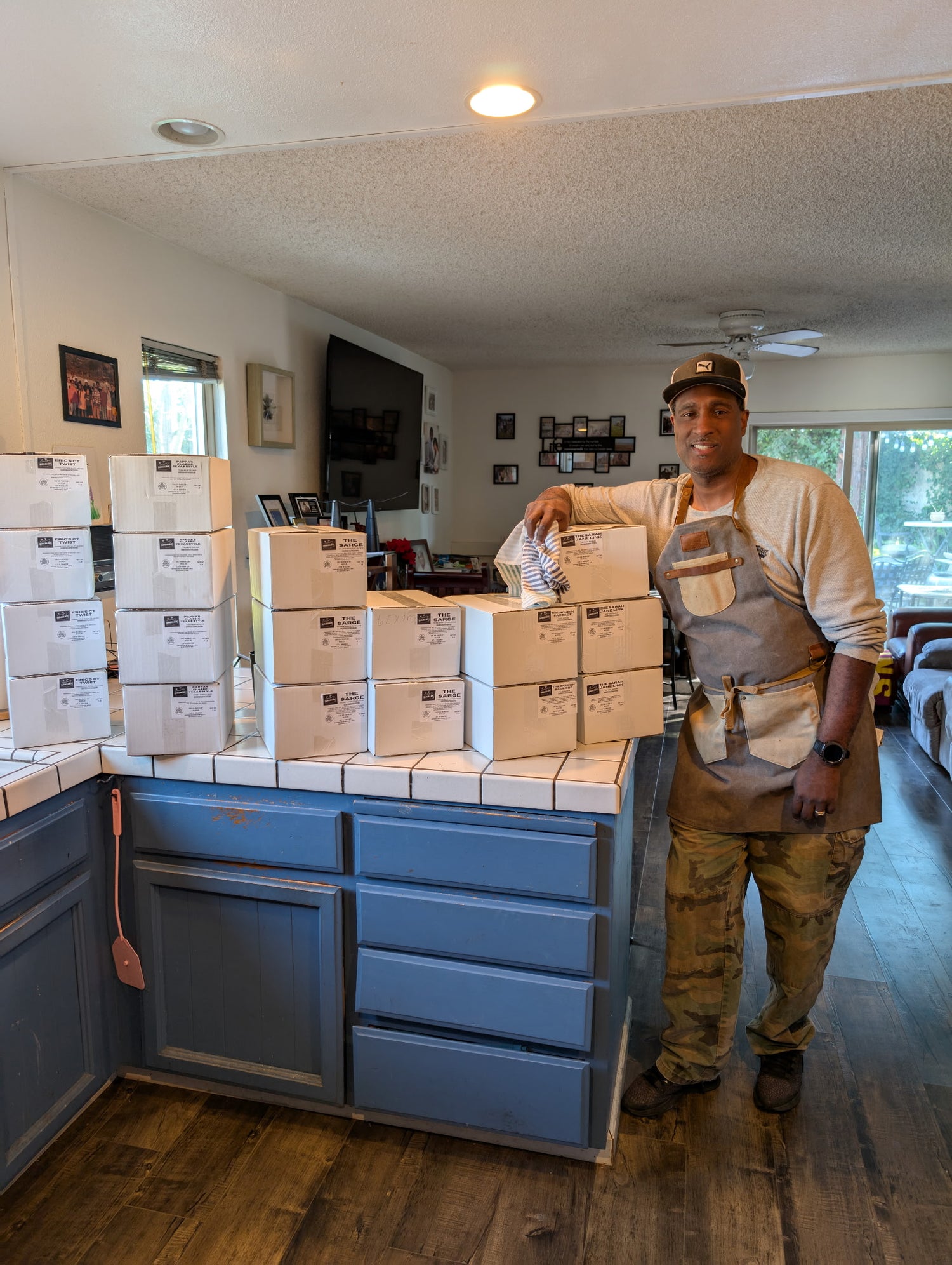Our founder, Malcolm, standing next to the very first batch of sausages